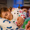 Kid sleeping with Elf on the Shelf Extraordinary Noorah™ Plush